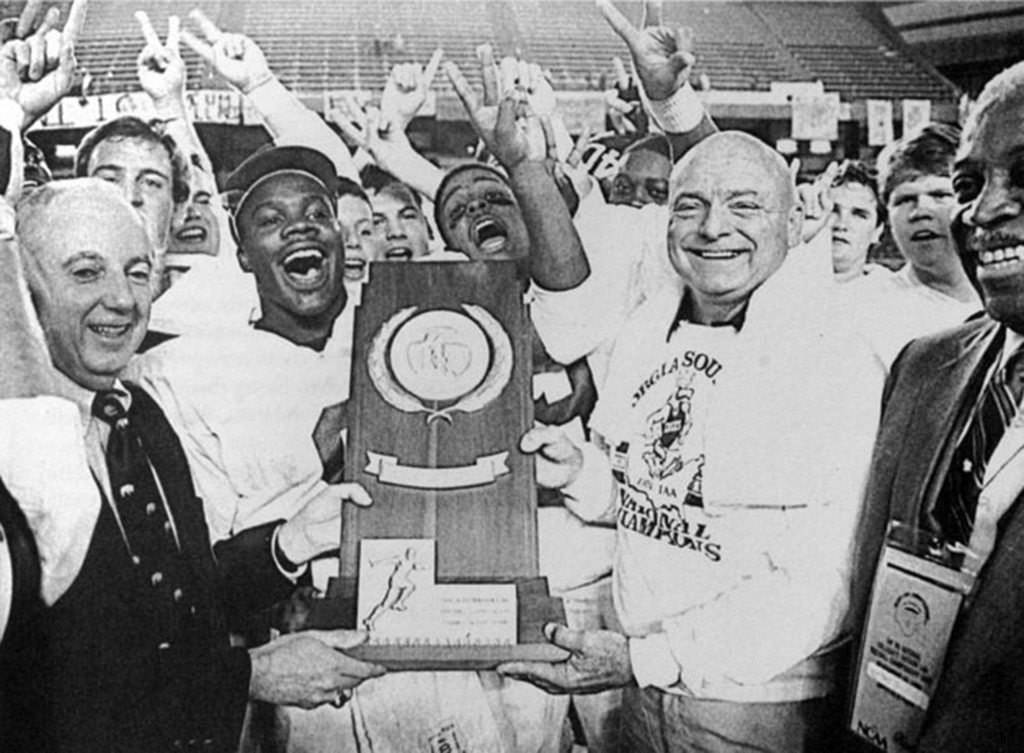 Erk Russell and the Georgia Southern Eagles celebrating with the 1986 NCAA Division I-AA national championship trophy