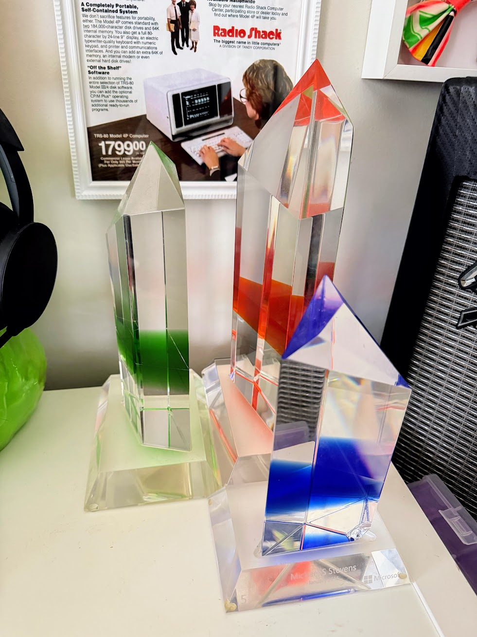 Microsoft anniversary crystals marking five years in blue, ten years in green, and fifteen years in orange