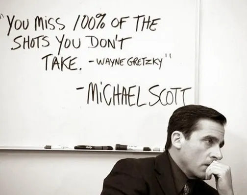Michael Scott sitting under a whiteboard quote: You miss 100% of the shots you don't take, attributed to Wayne Gretzky and Michael Scott