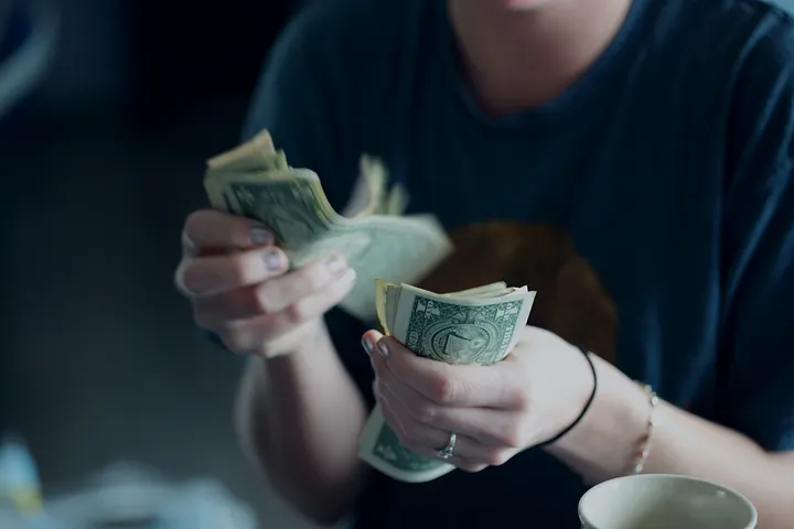 Hands counting dollar bills