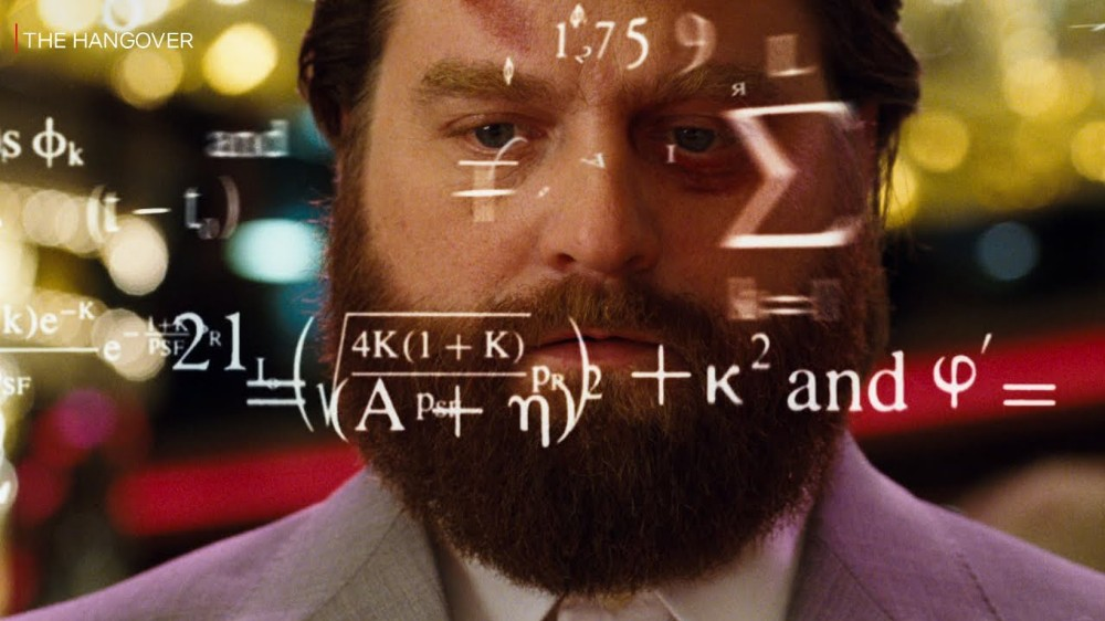 Alan from The Hangover concentrating while mathematical formulas appear around him