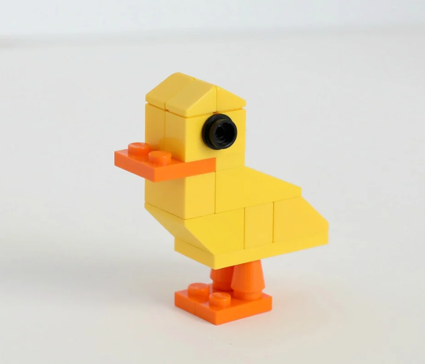A small yellow duck assembled from a handful of LEGO bricks