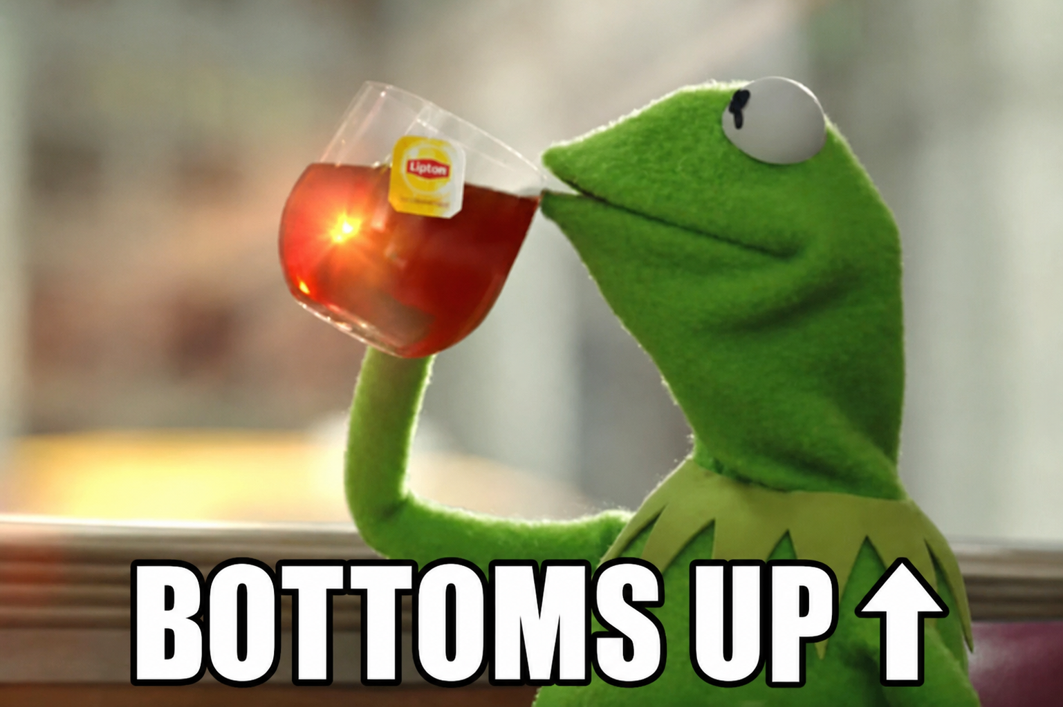 Kermit drinking tea above the words Bottoms Up and an upward arrow